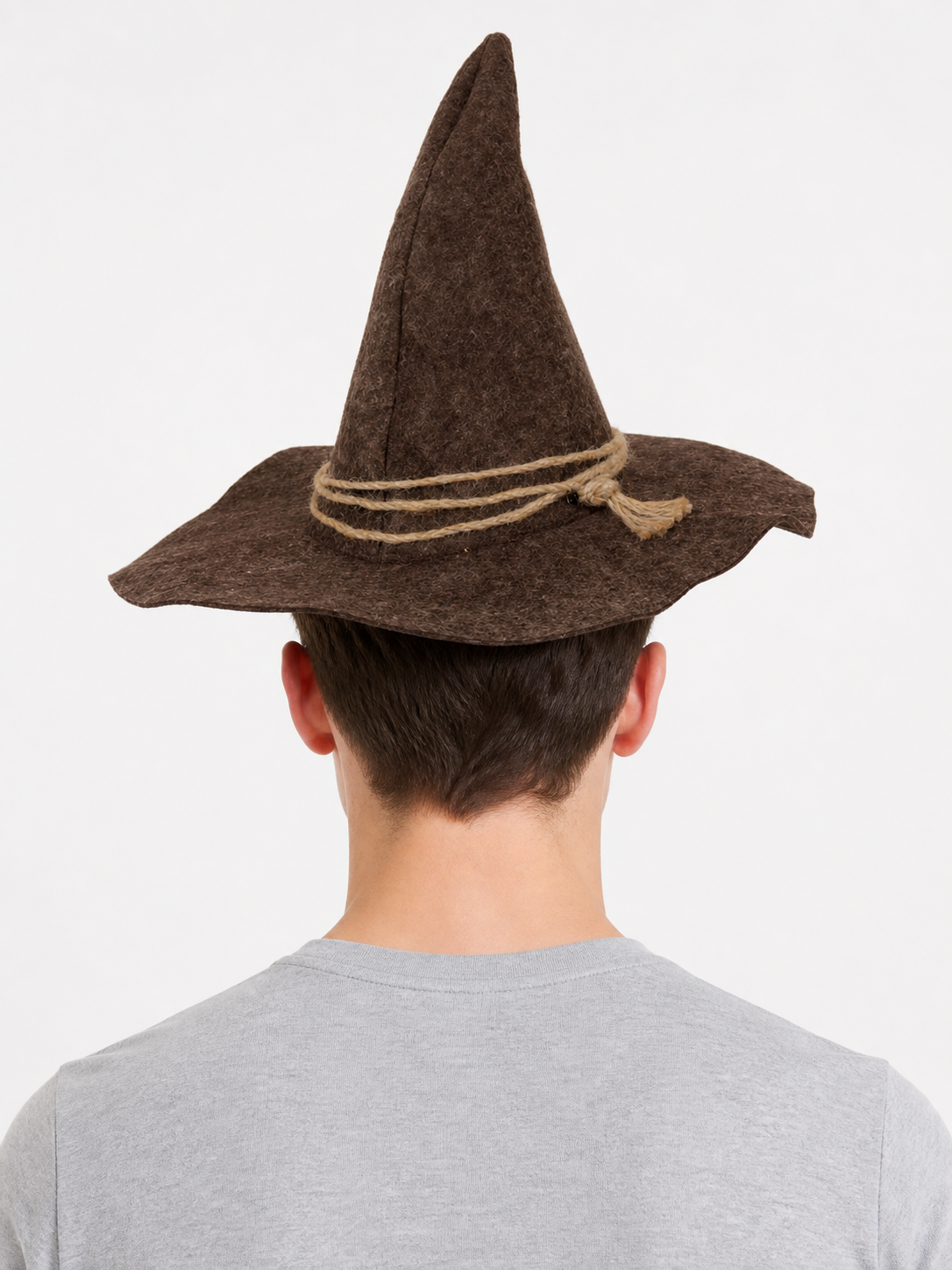 Back view of a man wearing a brown pointed costume hat with a wide brim and tan rope wrapped around the crown