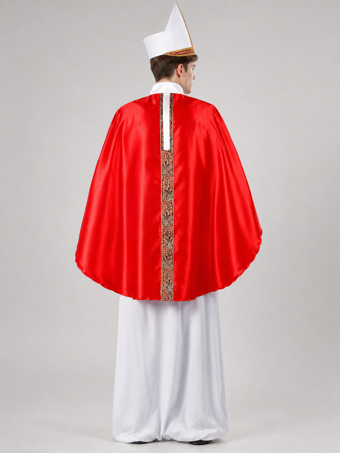 Rear view of a male model wearing a glossy red robe with a vertical gold-trimmed back panel, white undergarment, and pointed white hat