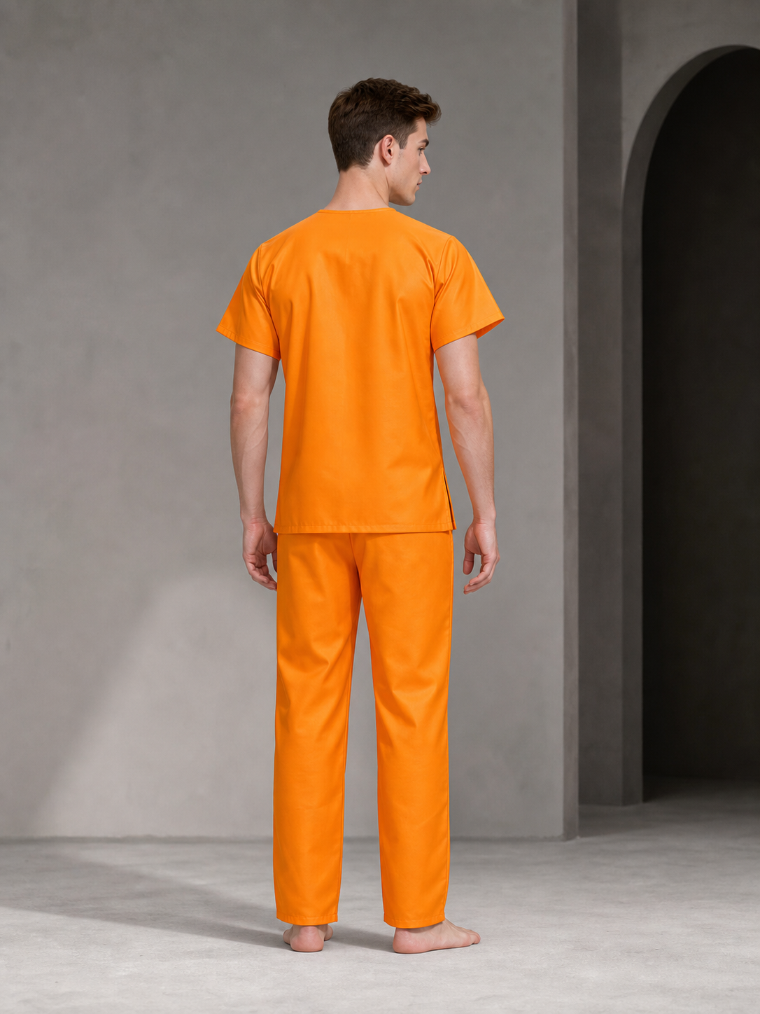 Orange two-piece costume set shown from the back on a model, with a short-sleeve shirt and long pants