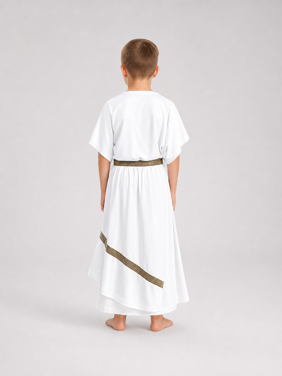Back view of a white draped costume tunic with a gold-patterned belt and diagonal trim, shown on a barefoot child against a gray background
