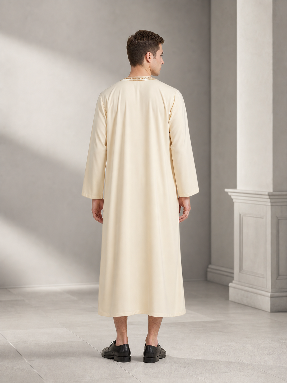 Long cream robe on a male model, shown full-body from the back in a styled interior, with long sleeves and a plain back