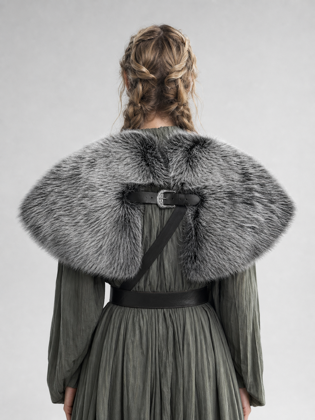 Back view of a gray fur-textured shoulder shawl with a black buckle and wide rounded shape on a model