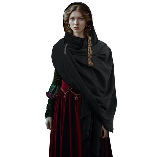 Model wearing the black hooded cowl scarf draped over the head and shoulders, pinned with a feather brooch, front view