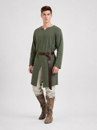 Green long-sleeve tunic shown on a model at three-quarter view, with a brown belt, front slit, cream trousers, and brown boots