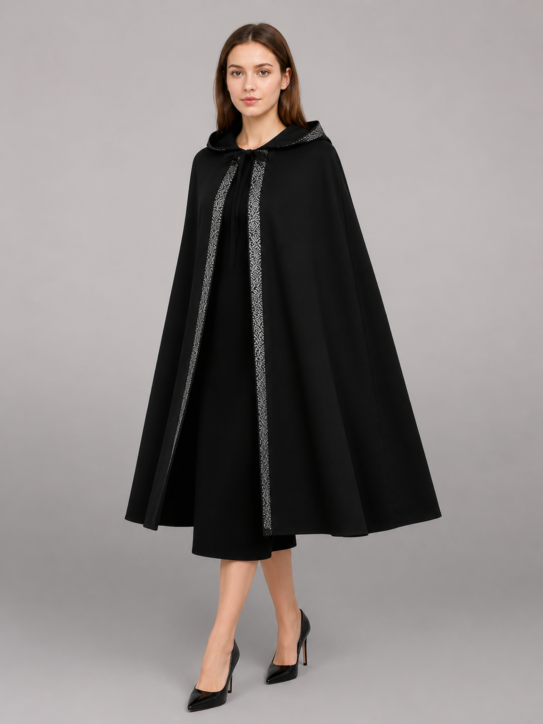 Black hooded cloak with silver patterned trim, shown from a front three-quarter angle on a model