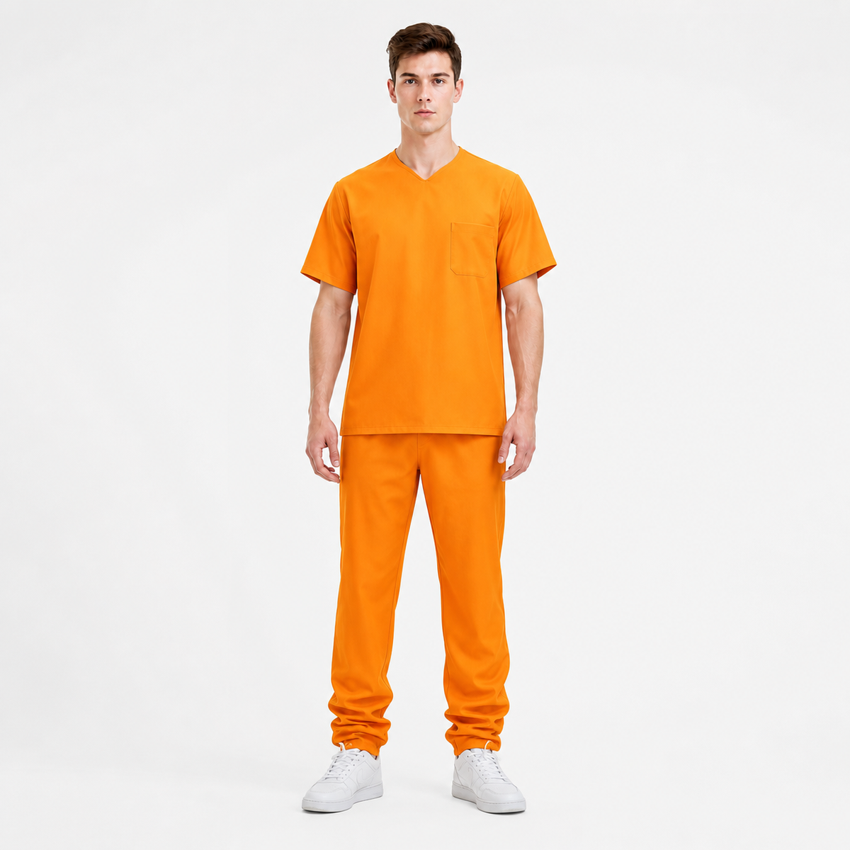 Orange short-sleeve shirt with chest pocket and matching pants shown full-body on a model against a light background