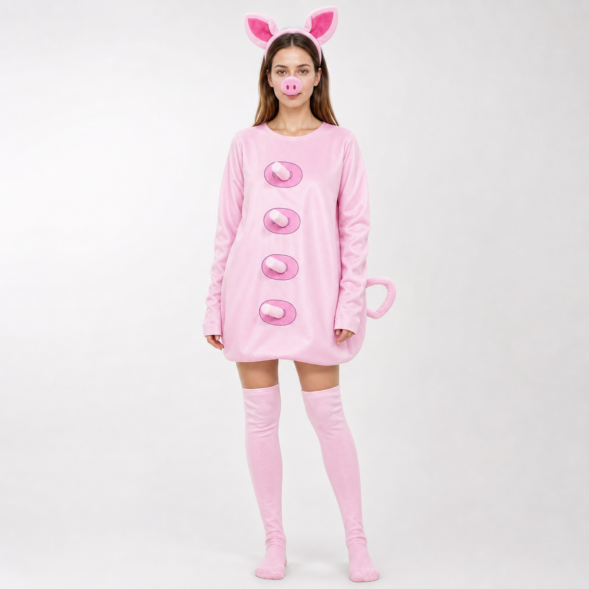 Full-body model wearing a smooth pink pig costume with long sleeves, four raised front details, pig ears, snout, curled tail, and thigh-high stockings