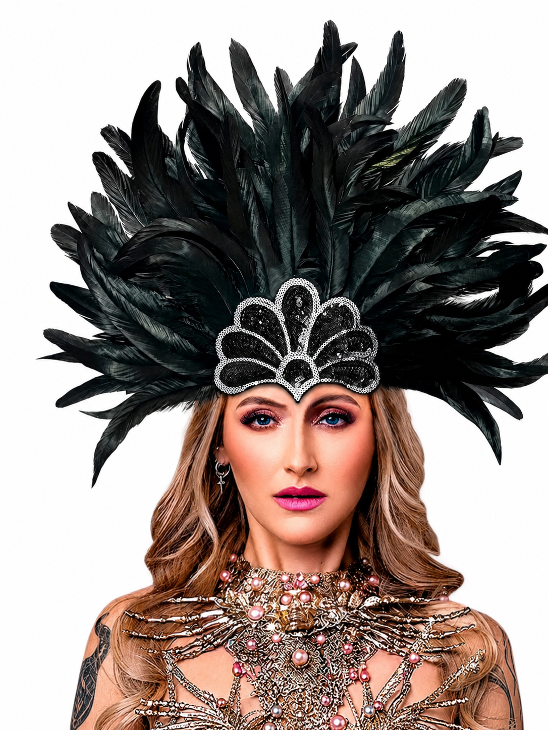 Black feather headpiece with a wide fan of layered plumes and a silver-edged scalloped sequin ornament, shown on a model