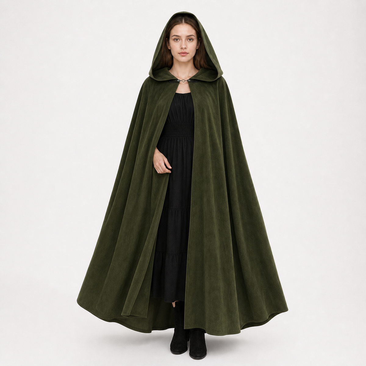 Dark olive green hooded cloak on a full-body female model, with a soft velvety look, front clasp, and long flared hem