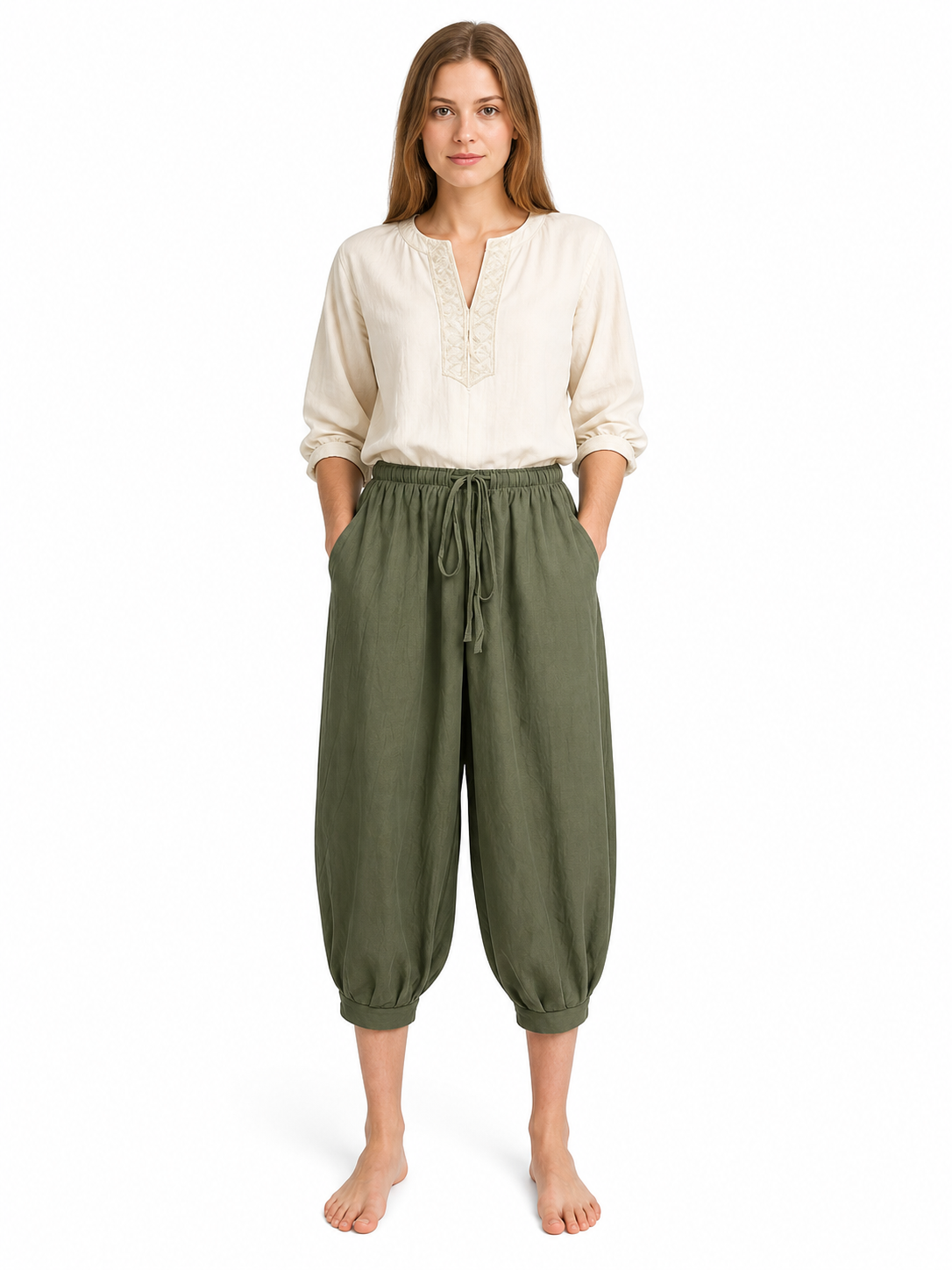 Olive green cropped harem pants with side pockets and front drawstring, shown full-body on a female model