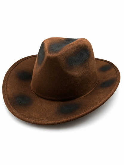 Brown cowboy hat shown from the front, with a wide stitched brim, pinched crown, and irregular black distressed-effect patches