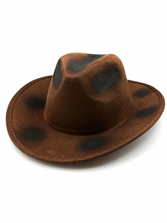 Brown cowboy hat with a wide brim, shaped crown, soft felt-like surface, and scattered black distressed-effect patches on a white background