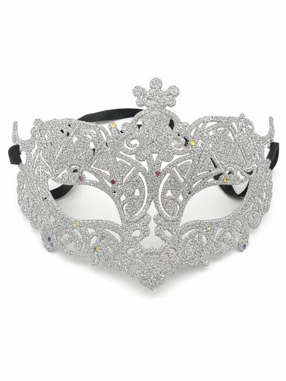 Silver glitter eye mask with ornate scrollwork, a raised central ornament, multicolored rhinestones, eye openings, and black side ties on white