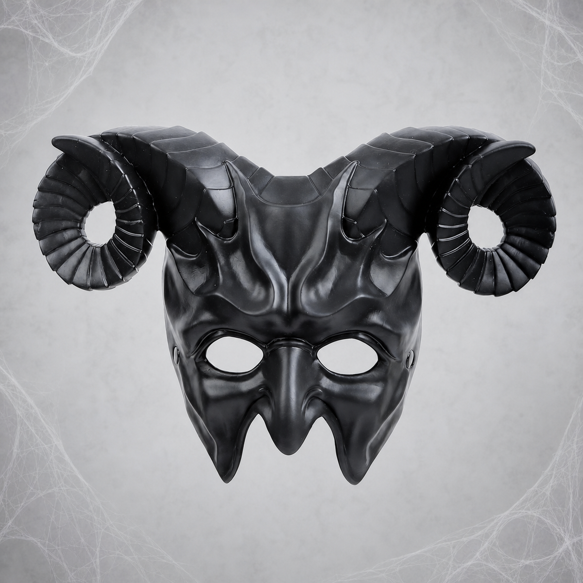 Black full-face demon mask with curled horns shown front-facing against a gray spiderweb background