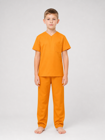 Full-body studio view of a child wearing an orange V-neck shirt with chest pocket and matching pants, barefoot
