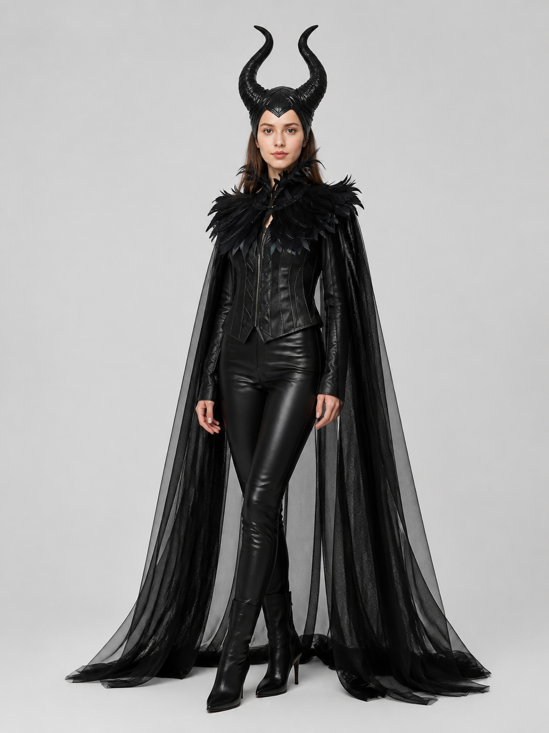 Black sheer cape with feather trim and horned headpiece shown full-body on a model wearing a glossy fitted outfit