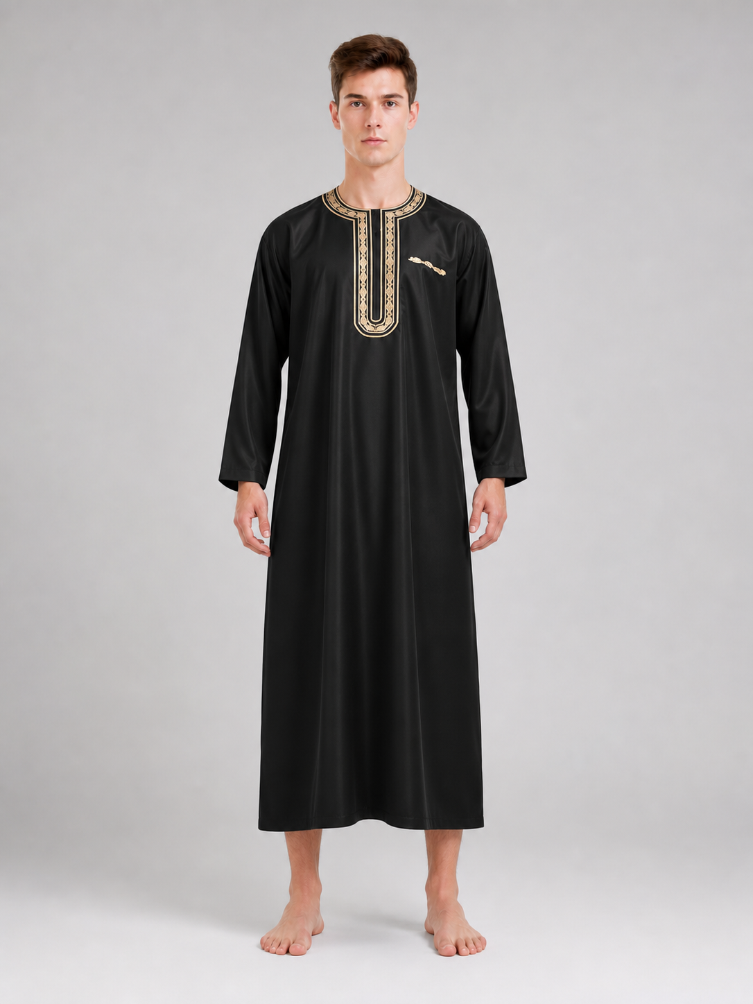 Black long robe with gold neckline and front placket, shown full-body on a barefoot model against a gray background