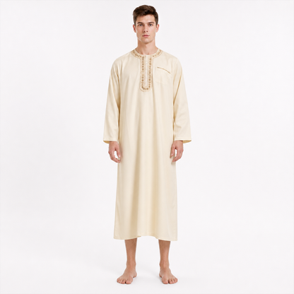 Long cream robe on a male model, shown full-body from the front, with long sleeves, an embroidered chest placket, and bare feet