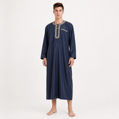 Navy blue full-length robe shown on a barefoot full-body model, featuring long sleeves and embroidered trim around the neckline and chest