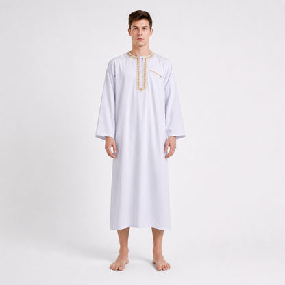 White ankle-length robe with gold-toned neckline and chest trim, shown from the front on a barefoot model