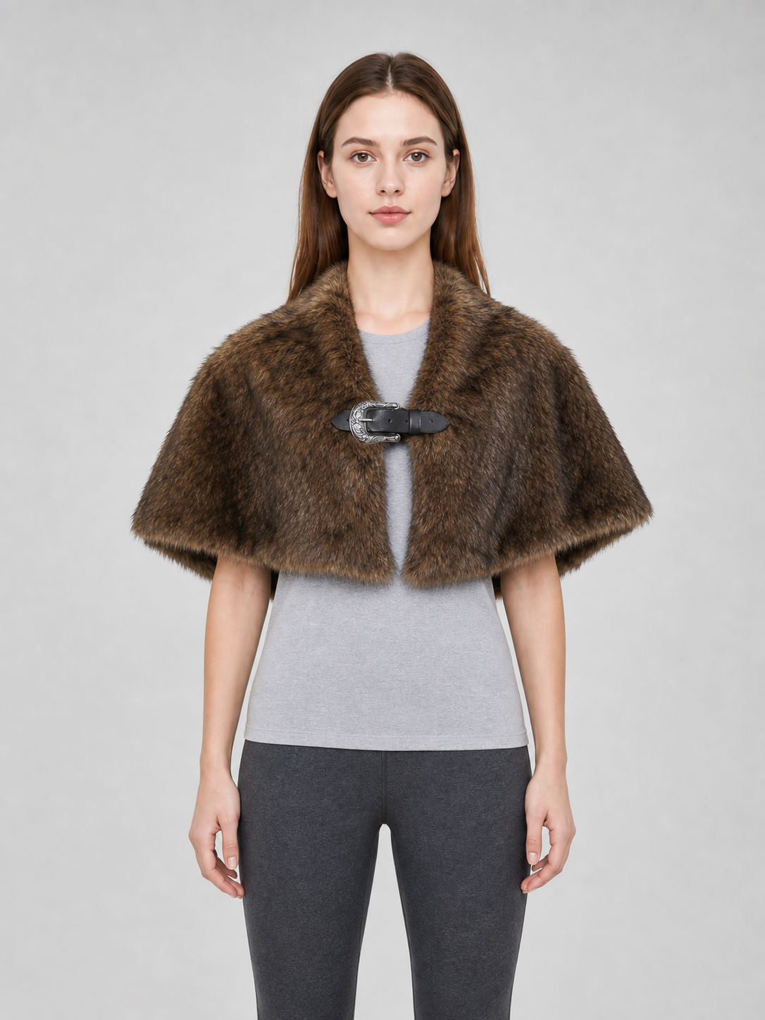 Brown fur-like shoulder cape with a black strap and silver buckle, shown from the front on a model