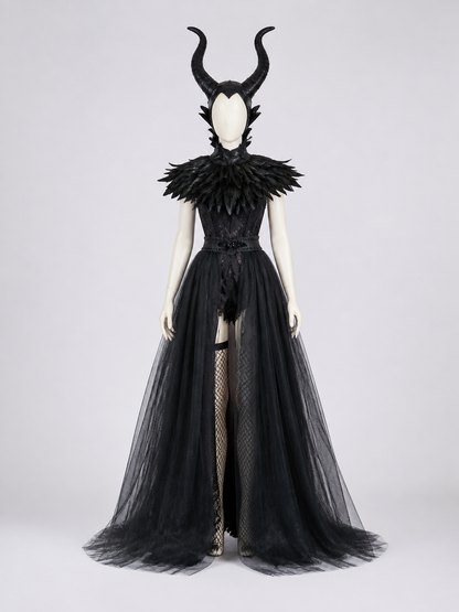 Front view of a black costume on a mannequin, featuring a horned headpiece, layered feather collar, fitted bodice, and sheer floor-length overskirt