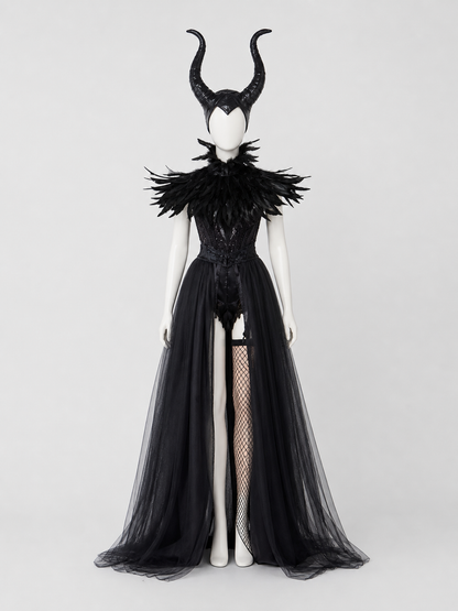 Full-body mannequin wearing a black costume with curved horns, feathered collar, fitted bodice, sheer split overskirt, and fishnet stocking