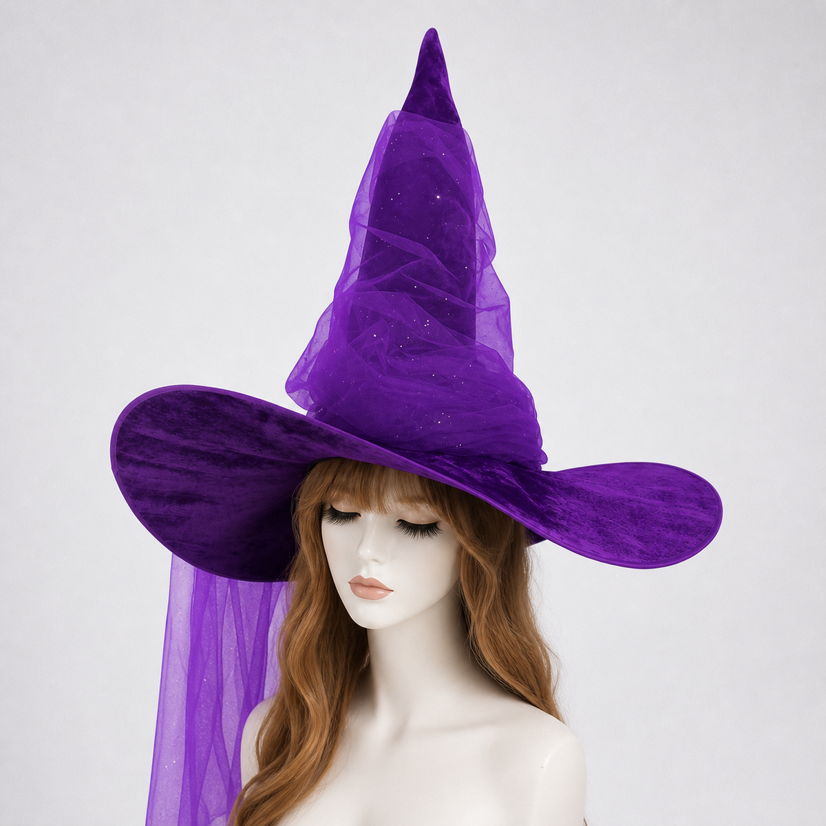 Purple witch hat with a tall pointed crown, floppy brim, sheer mesh drape, and glitter-like specks on a mannequin