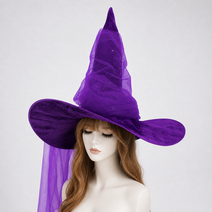 Purple witch hat with a tall pointed crown, floppy brim, sheer mesh drape, and glitter-like specks on a mannequin