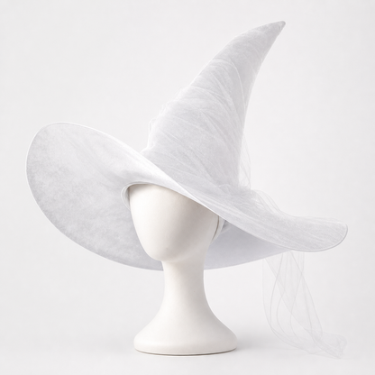 White sheer witch hat on a mannequin, with a wide floppy brim, tall curved crown, and trailing translucent veil