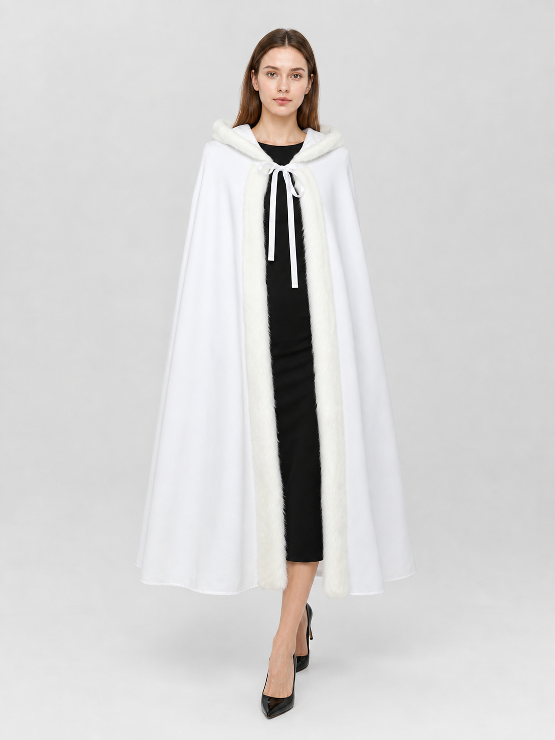 White hooded cape with fluffy front trim and hanging ties, shown full-length on a model against a plain background