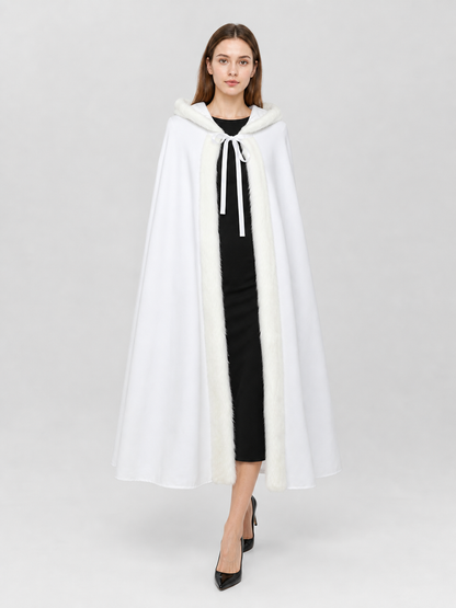 White hooded cape with fluffy front trim and hanging ties, shown full-length on a model against a plain background