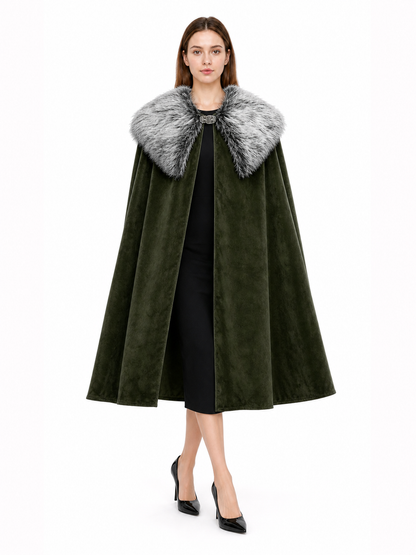 Olive green cape with a gray faux fur collar and front clasp, shown full-length on a model against a white background