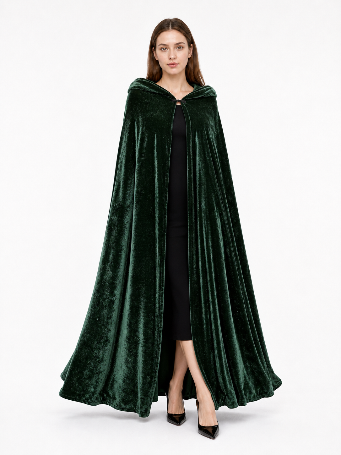 Dark green velvet-look hooded cape shown full length on a model, with a front clasp and wide flowing hem
