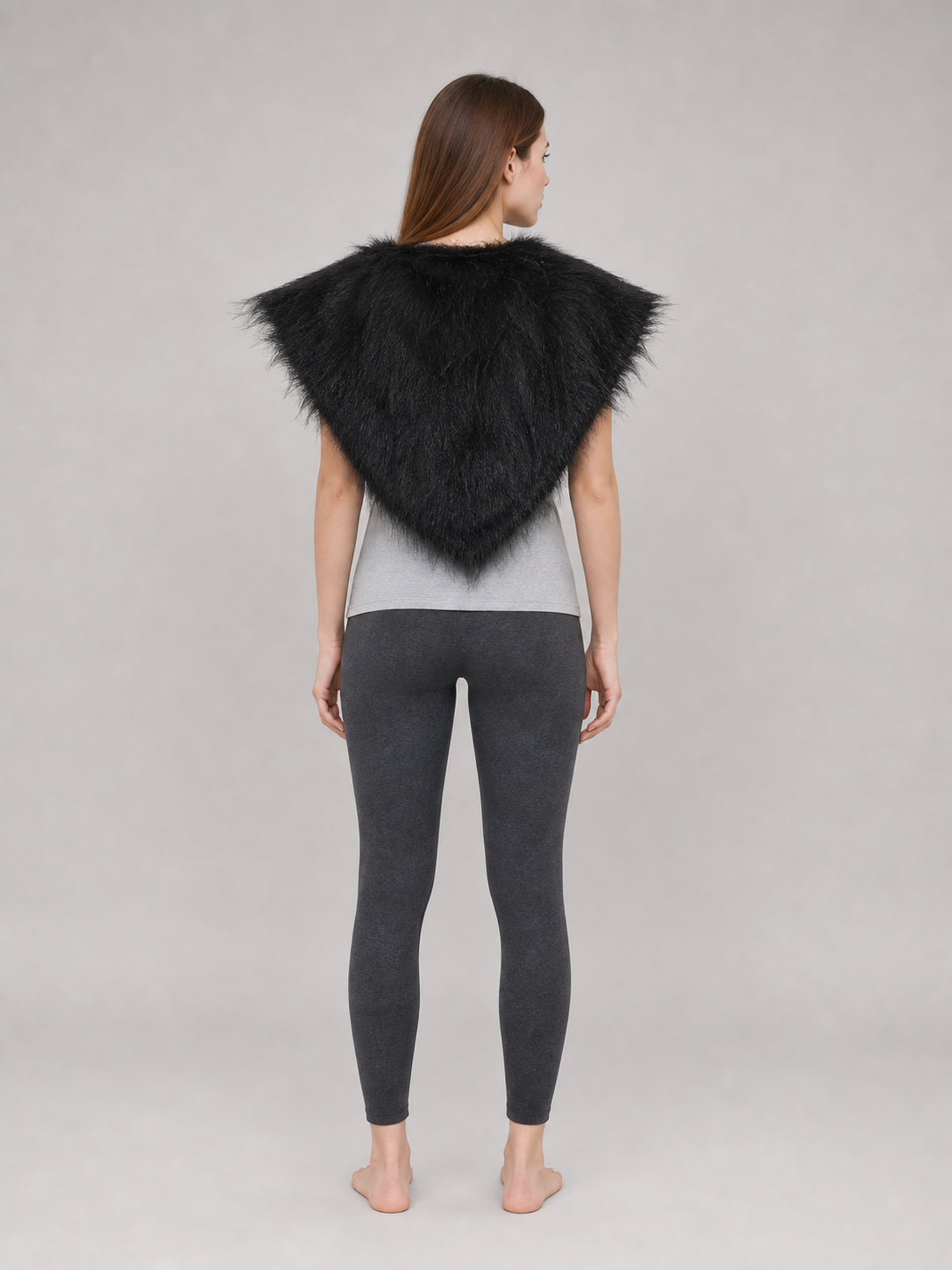 Black fur-like shoulder cape shown from the back on a standing model, forming a pointed triangular shape