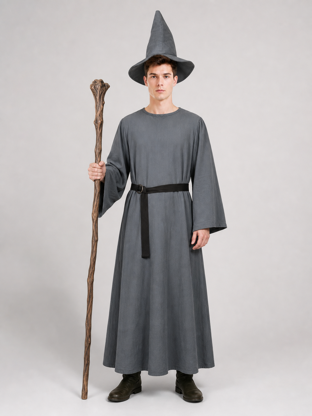 Full-body model wearing a gray robe, pointed hat, and black belt while holding a wooden staff