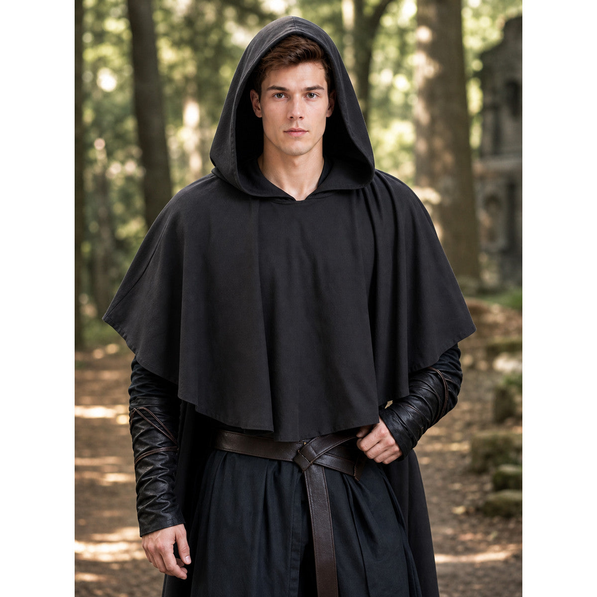Dark gray hooded poncho with a loose cape shape, shown on a male model in a forest setting