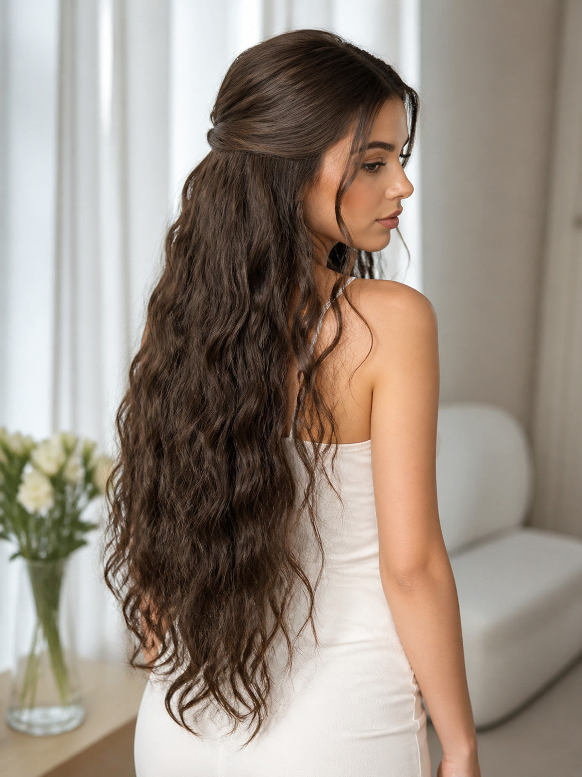Long brown wavy costume beard shown from behind on a woman, with the hair-like accessory extending down her back