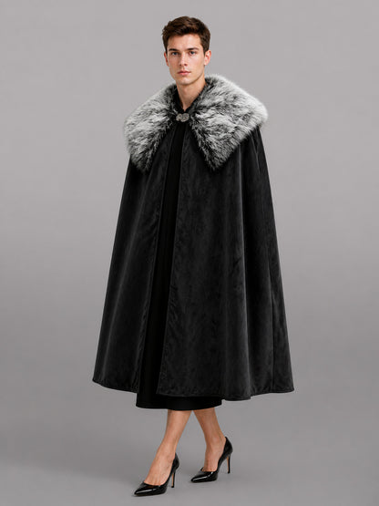 Black velvet-look cape with a gray faux fur collar and front clasp, shown full-length on a model