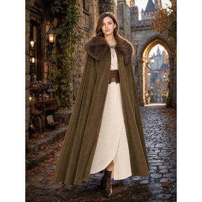 Full-length brown cape with a fur collar and open front, modeled over a light dress on a cobblestone street