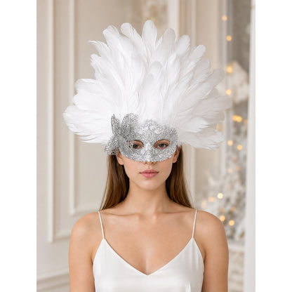White feather and silver filigree masquerade mask worn front-facing by a model in a white camisole