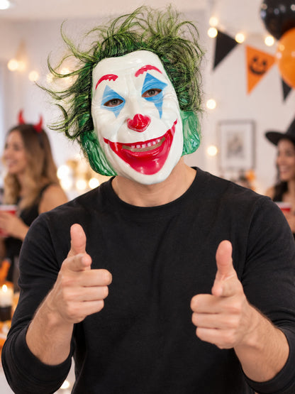 Clown mask with white face, red nose, green hair