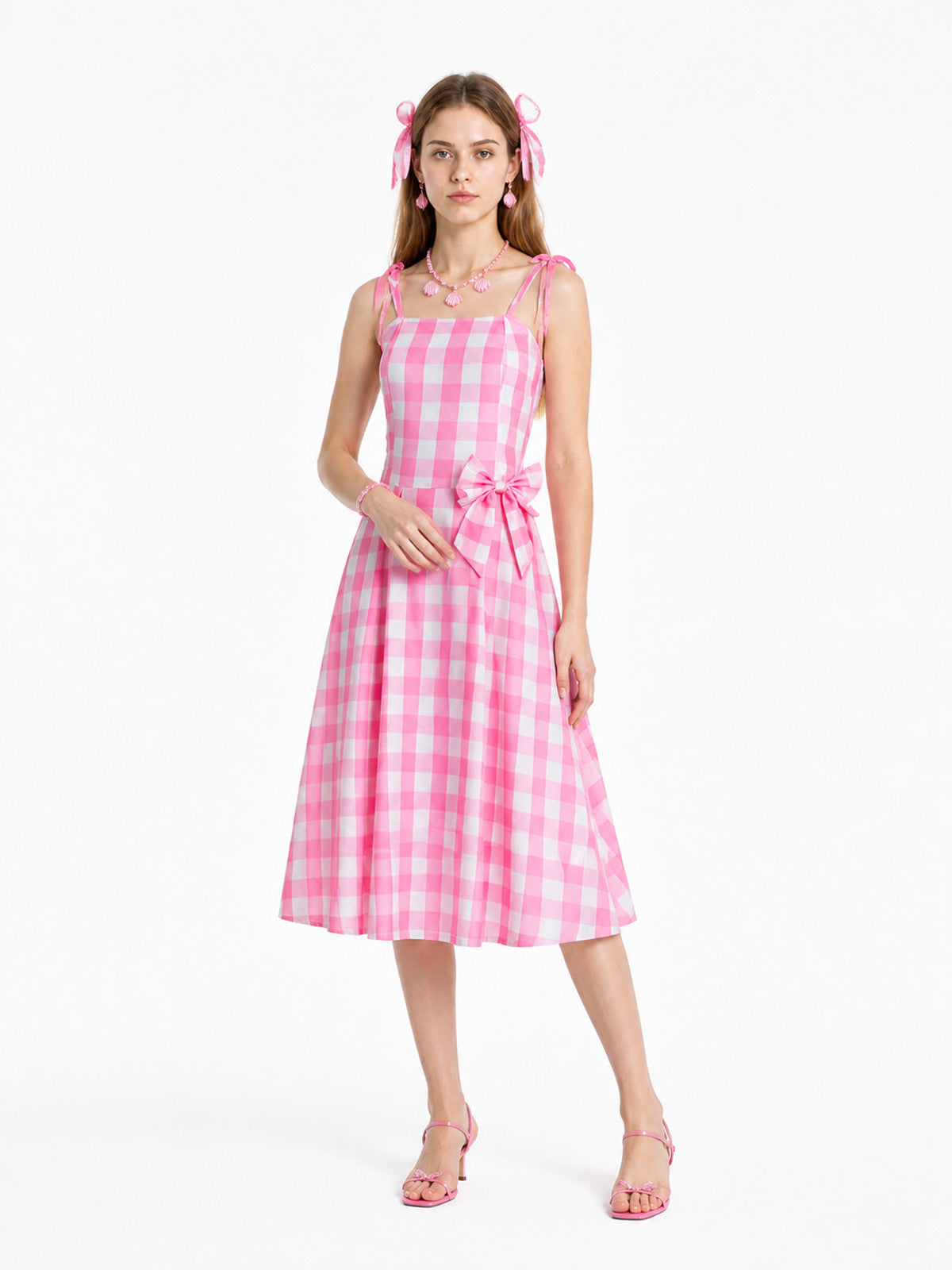 Pink-and-white gingham pinafore dress with a bow