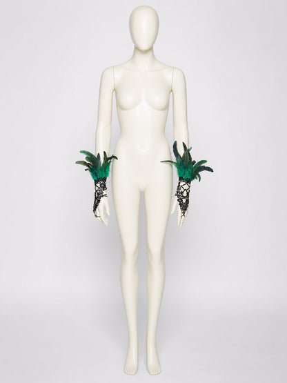 Black lace mesh fingerless gloves with green and black feathers, displayed on a full-body mannequin