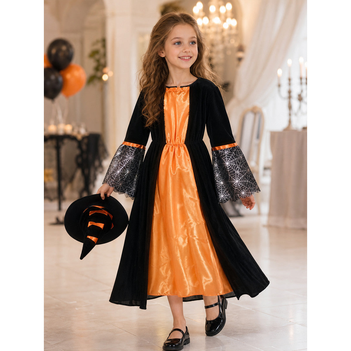 Witch-style costume set featuring a long black dress with long sleeves, a wide flared bottom, and a black pointed hat. The design uses orange, silver, and black colors. The center front of the dress features an orange decorative element, an