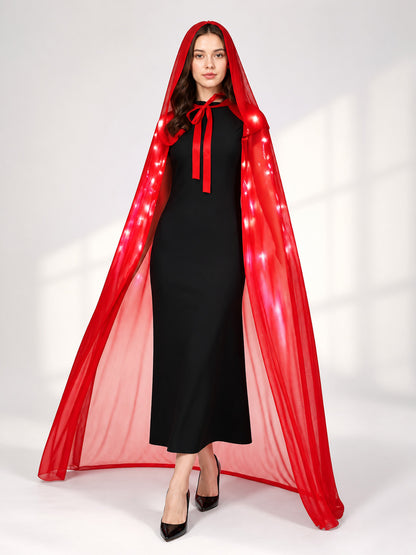 Front view of a model in a sheer red hooded cape with illuminated lights and long tie ribbons