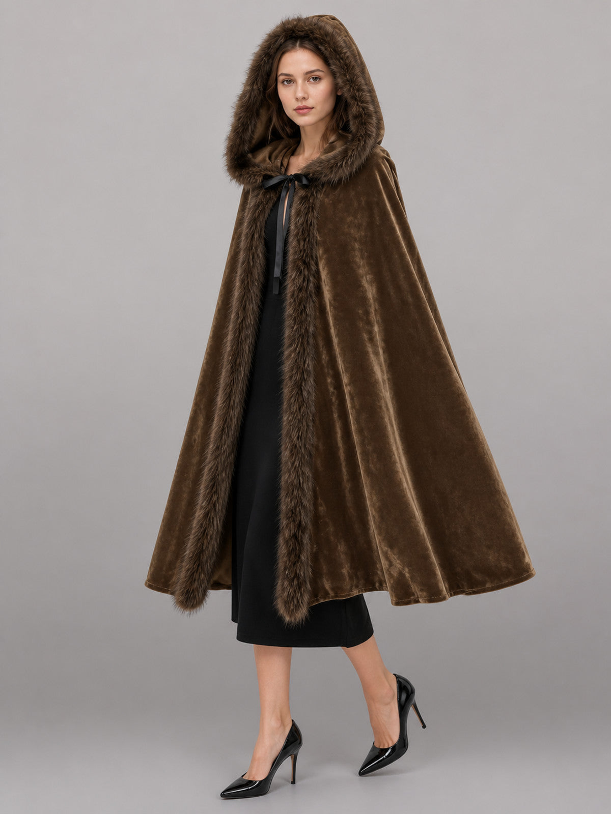 Brown hooded cape with plush faux-fur edging and front tie, shown full-body on a model
