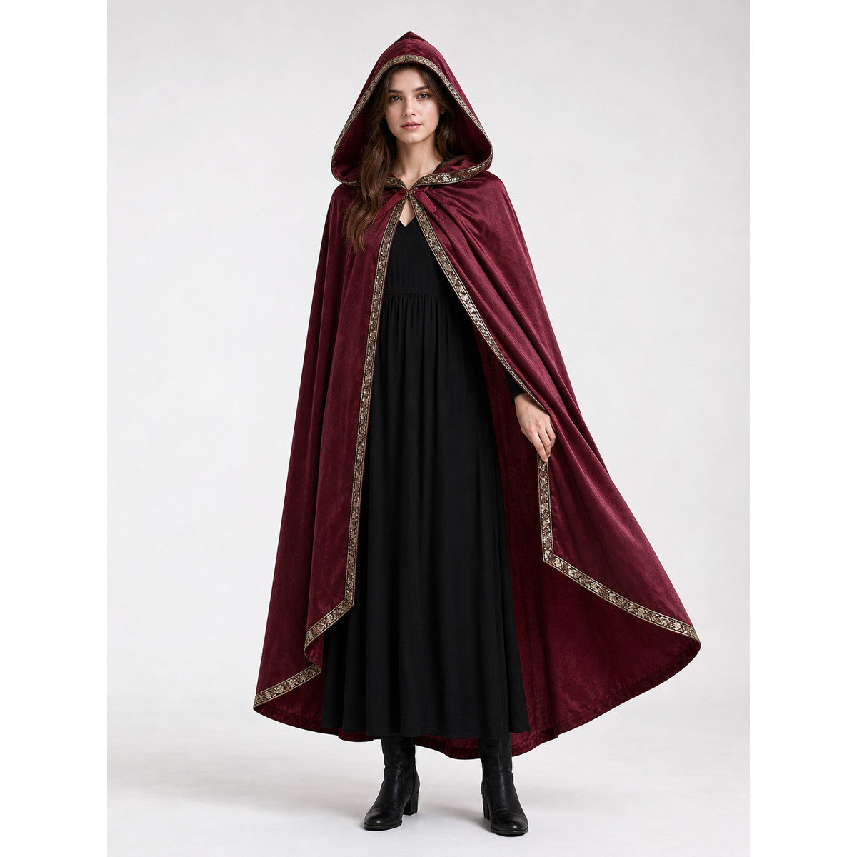 Burgundy hooded cape with gold trim shown on a female model over a long black dress in a full-body studio view
