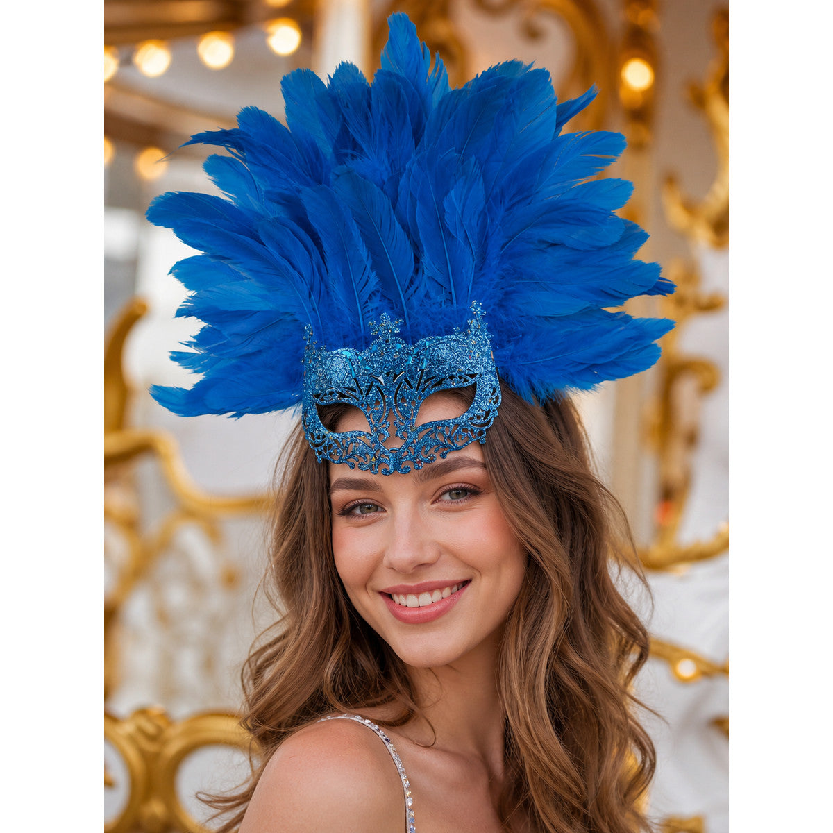 Blue feather eye mask worn by a smiling woman in a decorated indoor setting