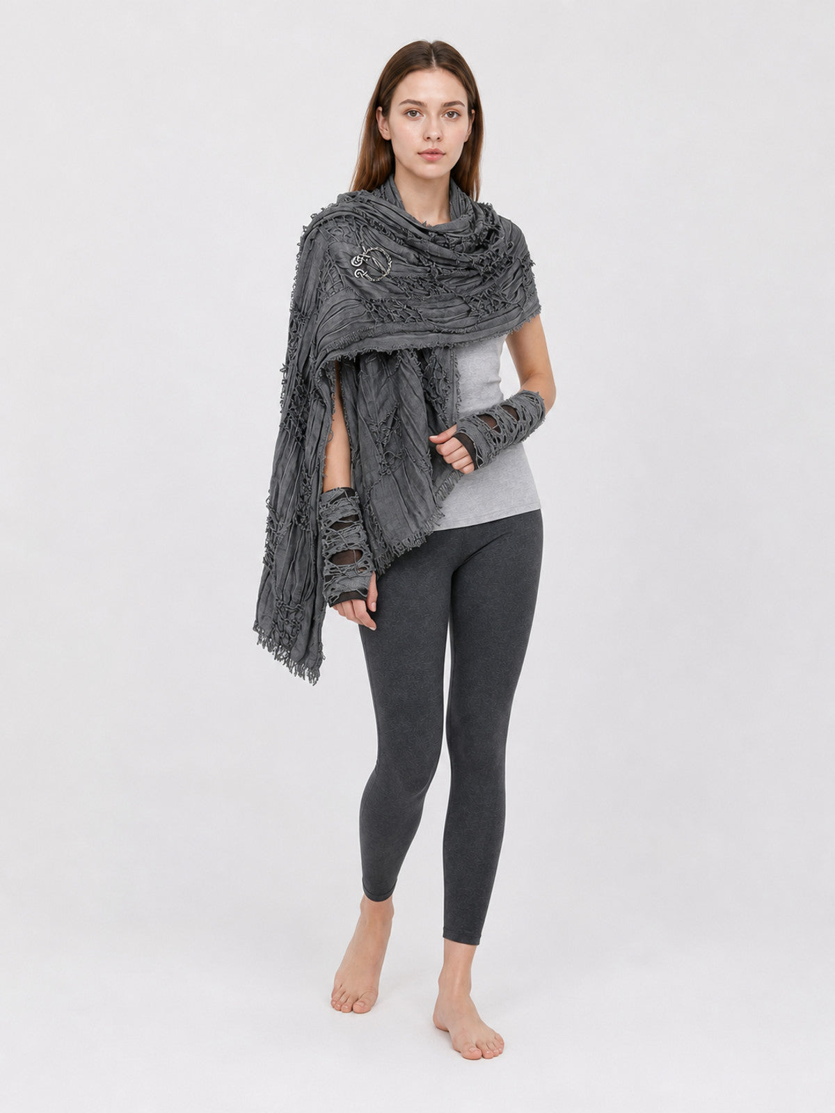 Gray hooded scarf with fingerless gloves, layered distressed fabric and long fringed ends, shown on a barefoot model